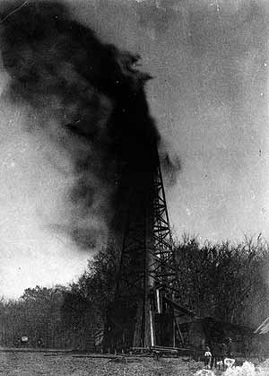 1897-NellieJohnson Spectators watched an Oklahoma oil gusher.