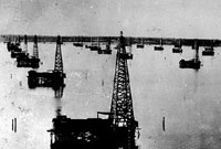Circa 1911 oil derricks on Caddo Lake, LA.