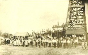 Cisco-oil-well-AOGHS Crowd posing in front of oil wells near Cisco, Texas, circa 1920.