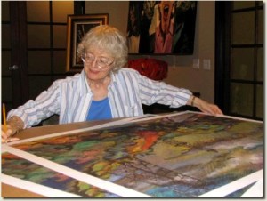 oilfield artist JoAnn Cowans with an oilfield print.
