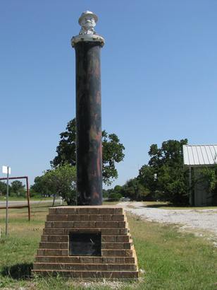 Joe-Roughneck-Boonsville-AOGHS Joe Roughneck plaque and statue on oil pipe in Boonsville, Texas.
