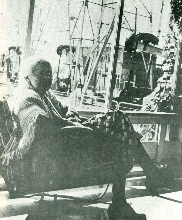 lou della crim sitting in front of her Eat Texas oil wells.